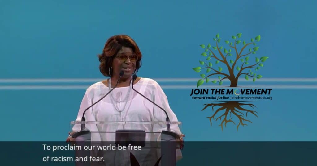 Screenshot of General Synod livestream featuring Rev. Dr. Velda Love and captions, "To proclaim our world be free of racism and fear" and the Join The Movement tree graphic.