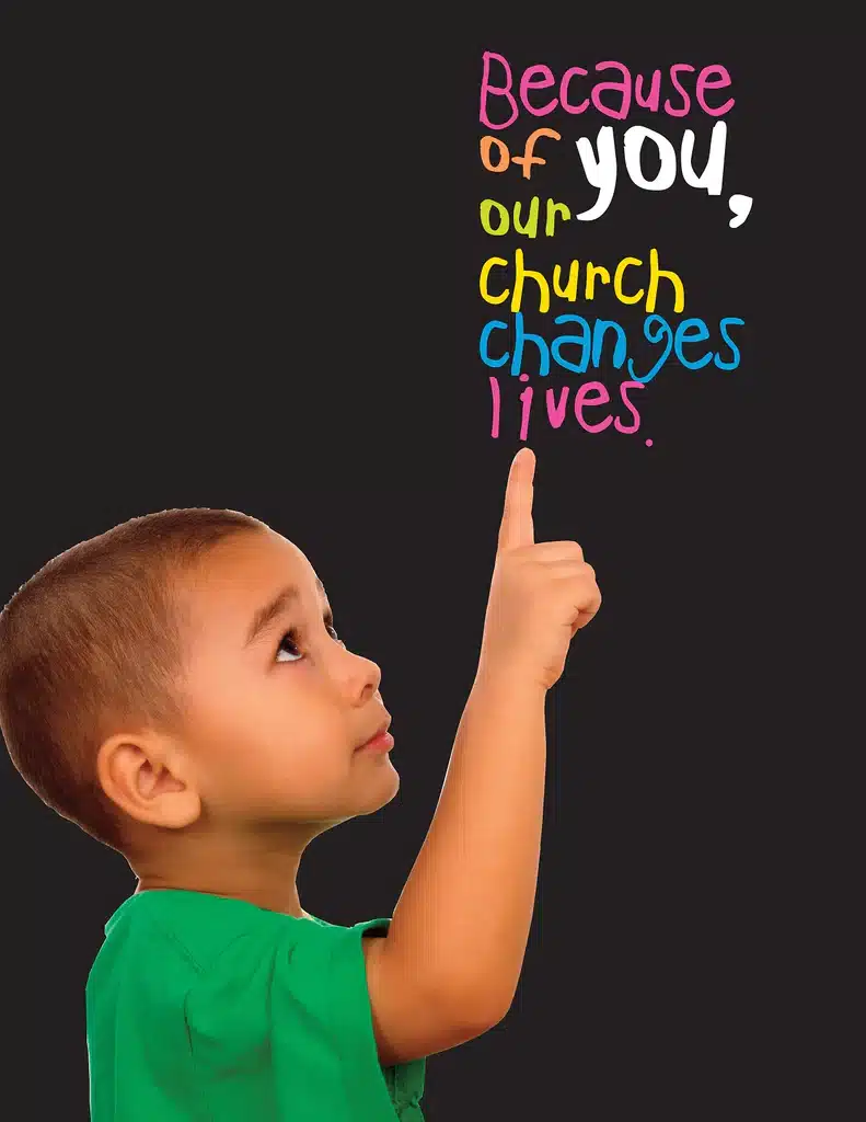 Child point to words "Because of you, our church changes lives"