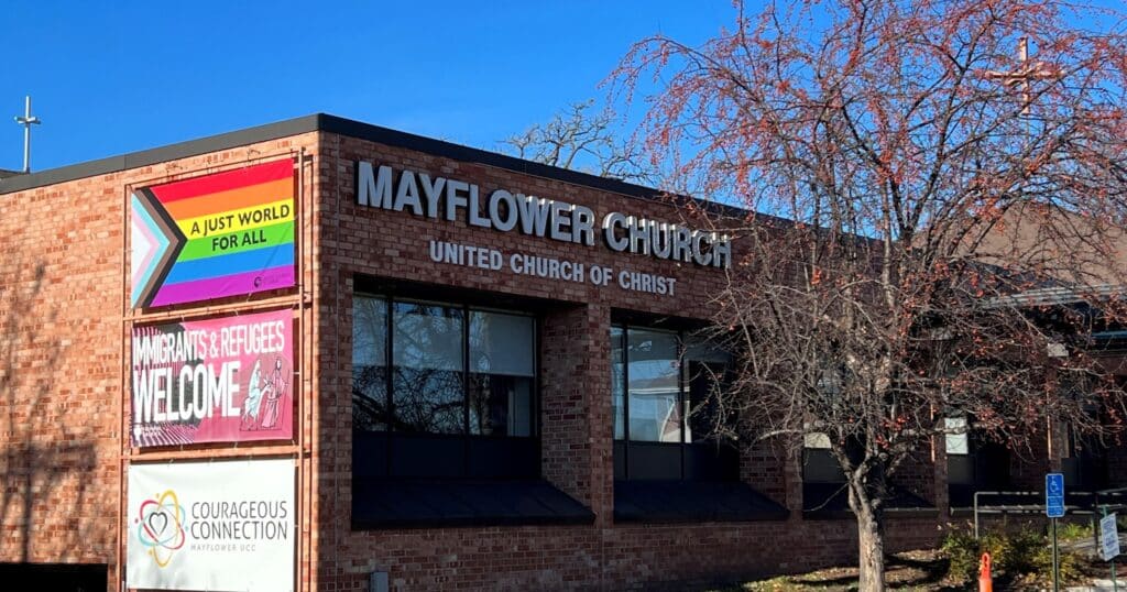 Church building says Mayflower Church UCC, Just world for all, migrants and refugees welcome