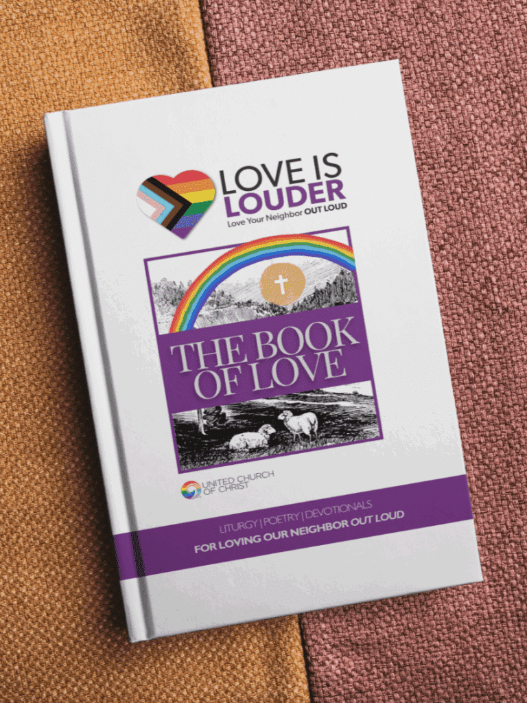 The Book of Love featuring the rainbow "Love is Louder" logo rests on a brown blanket