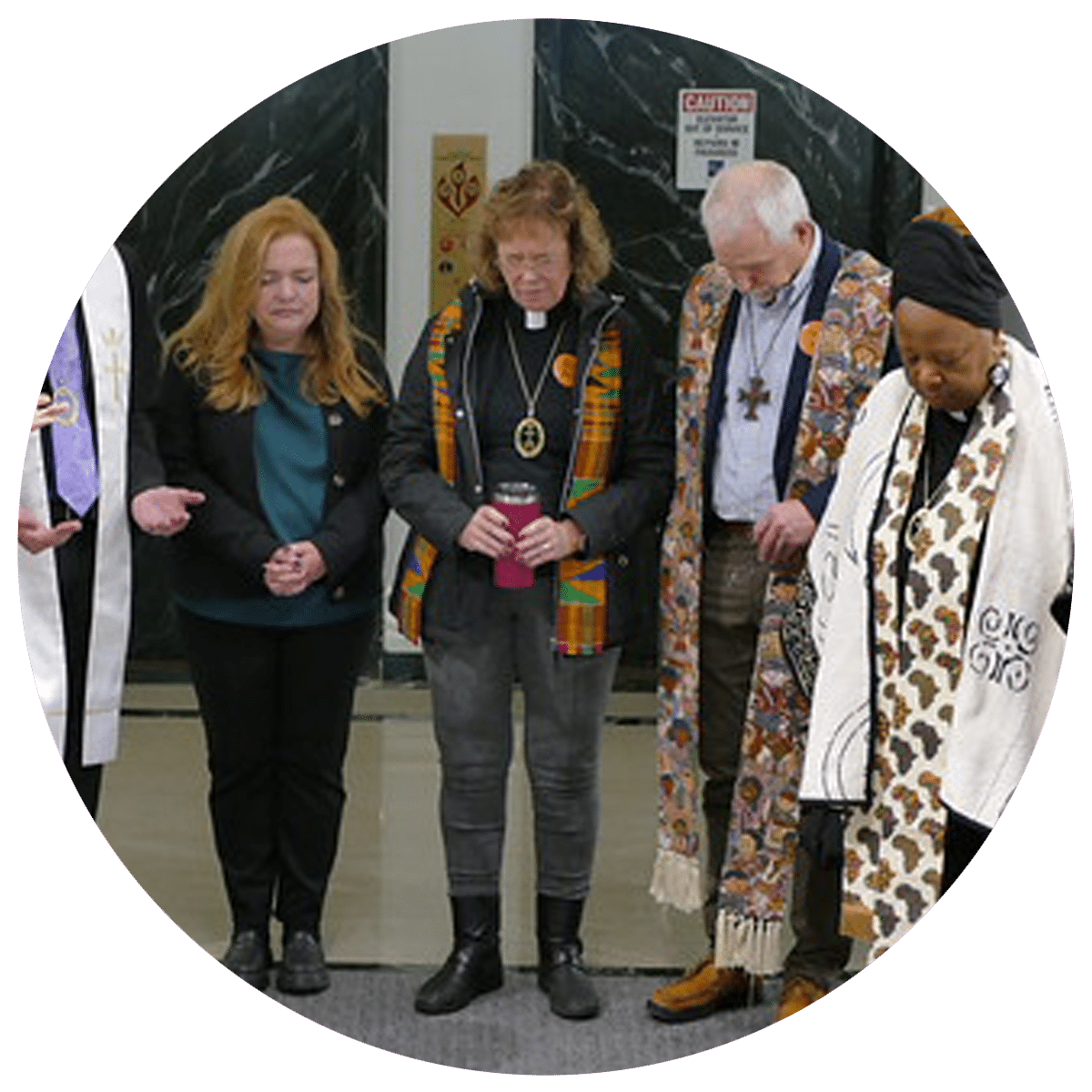 Members of the Council of Conference Ministers pray together with Megan Bergert, Minister for Refugee and Migration Services